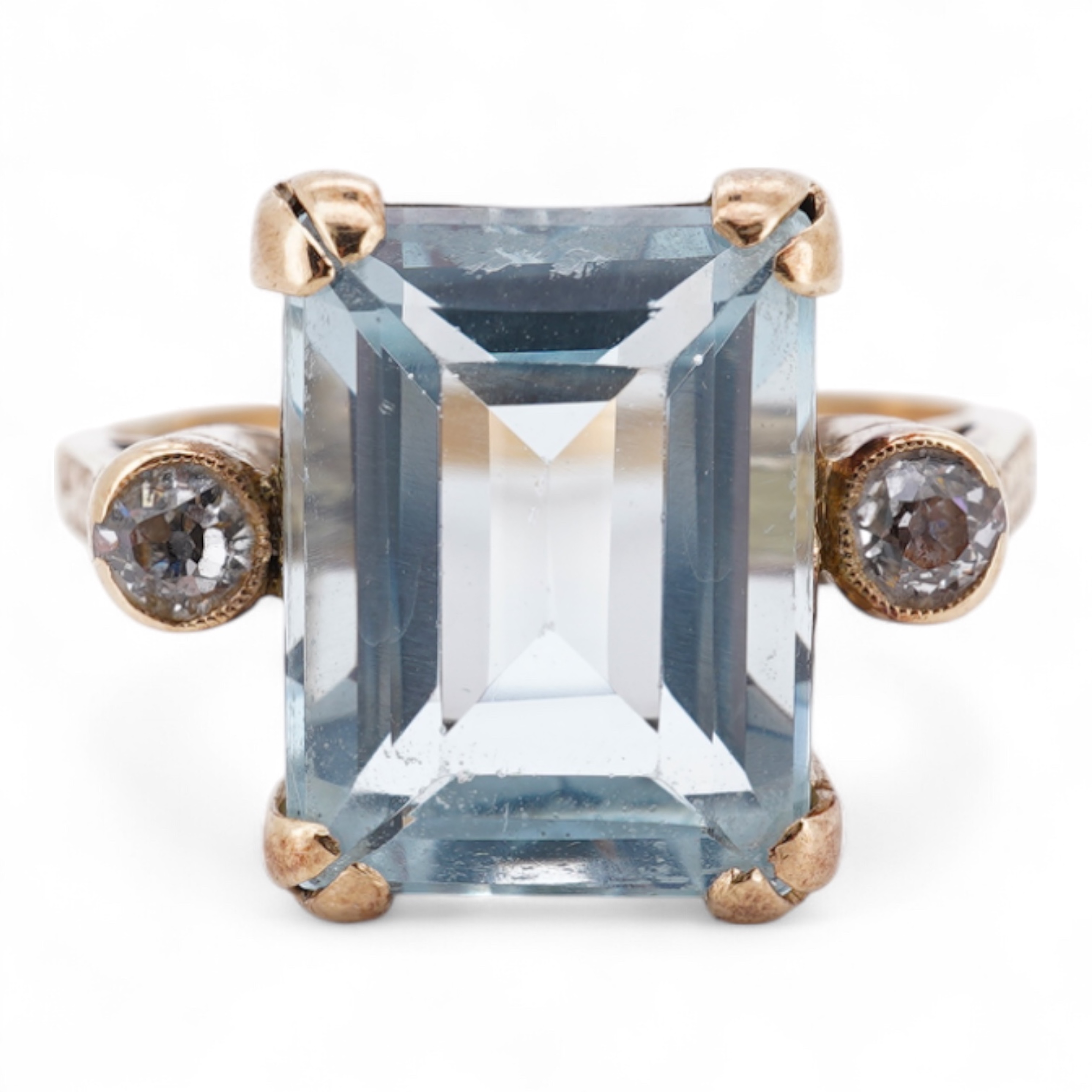 A yellow metal and single stone emerald cut aquamarine set ring, with two stone diamond set shoulders, size M, gross weight 4.2 grams.